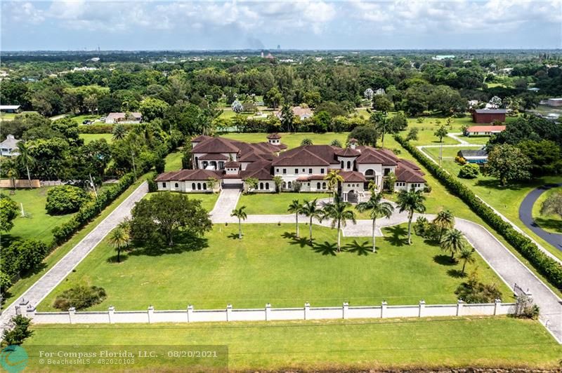 an aerial view of residential houses with outdoor space and swimming pool