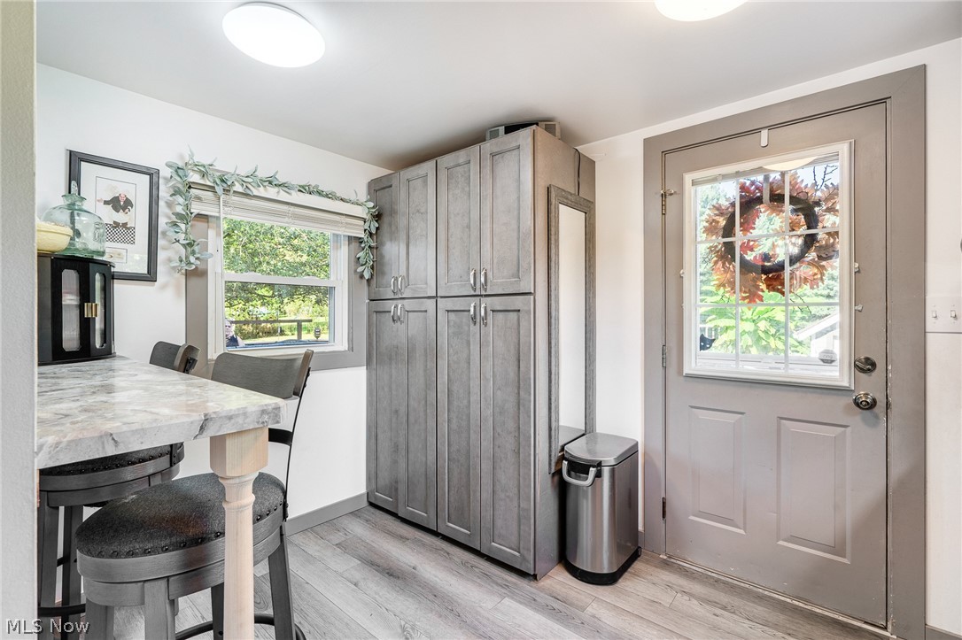 5840 Poland Struthers Road Youngstown, OH 44514 - Photo 26 of 50 Expansive built-in cabinetry, wood-finish flooring, a window providing natural illumination, and a door with an integrated window feature in this space