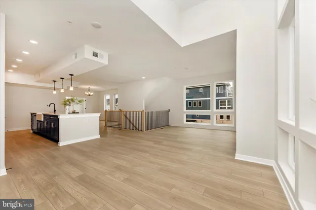 a view of an empty room with a window and fireplace