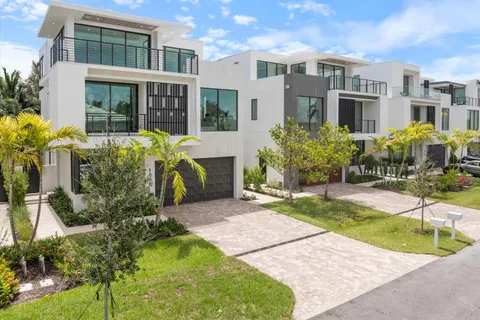 a front view of a residential apartment building with a yard