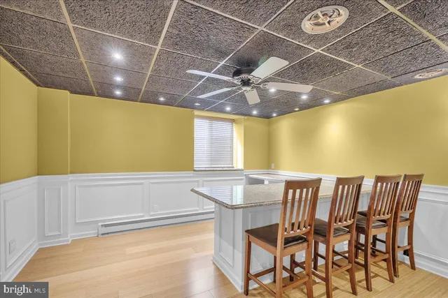 a view of a dining room with furniture and a chandelier