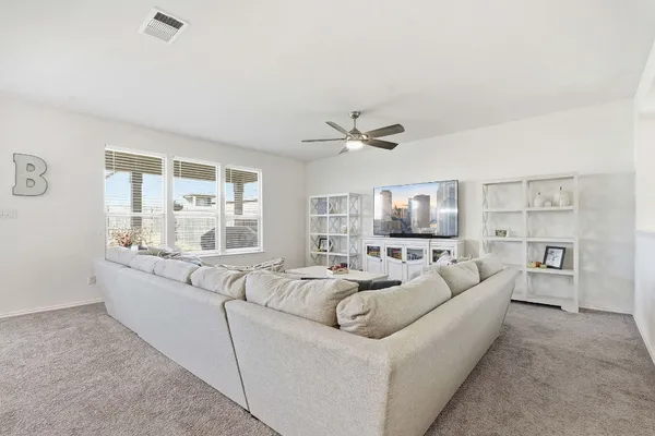 a living room with furniture and a large window