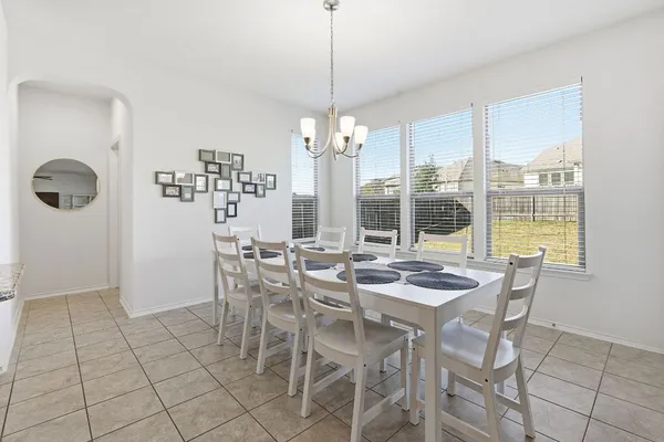 a view of a dining room with furniture and windows