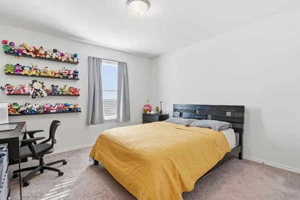 a bedroom with a bed and dresser