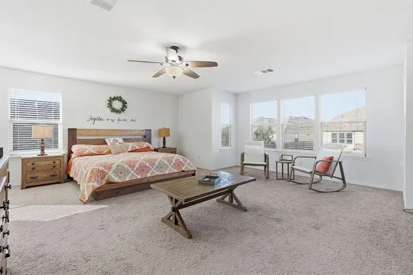 a bedroom with a bed a table and chair