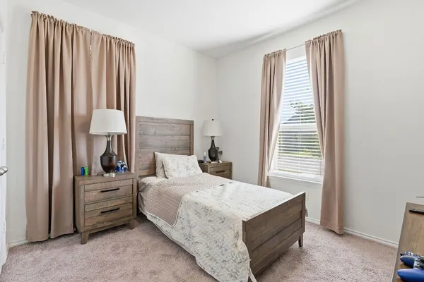 a bedroom with a bed and a chair