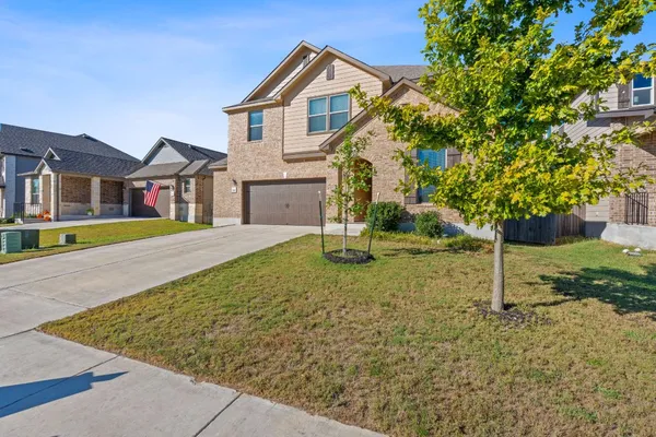 a front view of a house with a yard