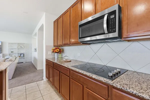 a kitchen with stainless steel appliances granite countertop a sink and a microwave