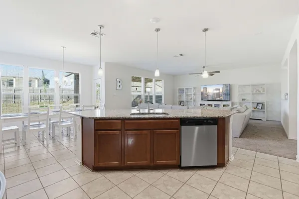 a kitchen with stainless steel appliances granite countertop a sink and cabinets