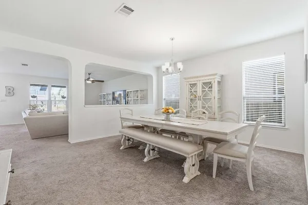 a view of a dining room with furniture and window