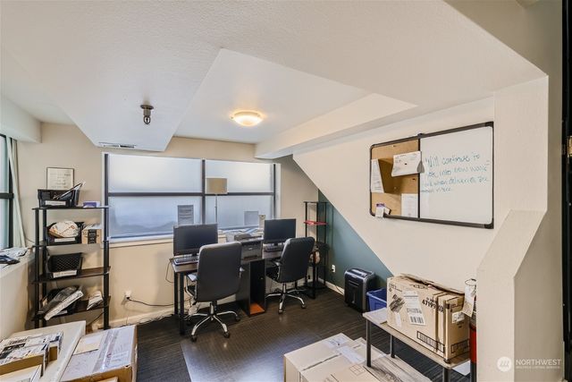 a view of a workspace with furniture and wooden floor