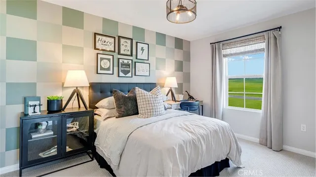 a bed sitting in a bedroom next to a window