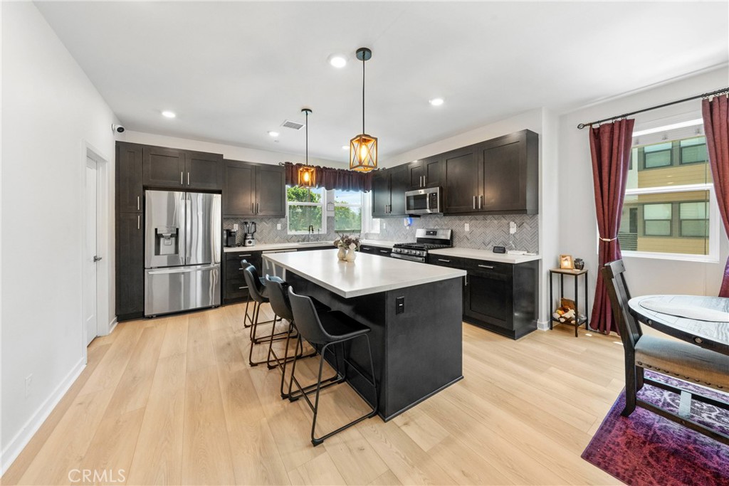 710 South Grable Circle Orange, CA 92868 - Photo 6 of 29 a kitchen with a sink stainless steel appliances and dining table