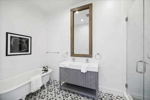 a bathroom with a bathtub sink and mirror