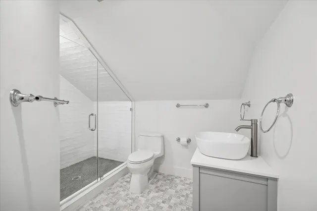 a white toilet sitting next to a bathroom sink