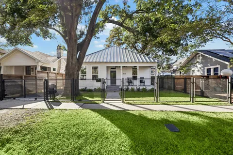 a view of house with a backyard and a tree