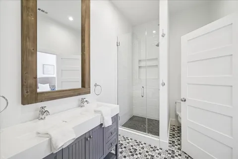 a bathroom with a sink and a mirror with bathtub