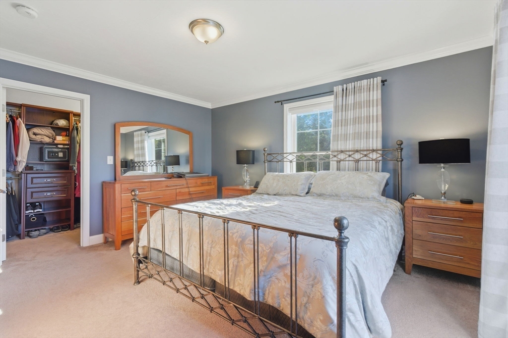 66 Compass Point, Unit 66 North Andover, MA 01845 - Photo 30 of 42 a bedroom with a bed and a flat tv screen on dresser