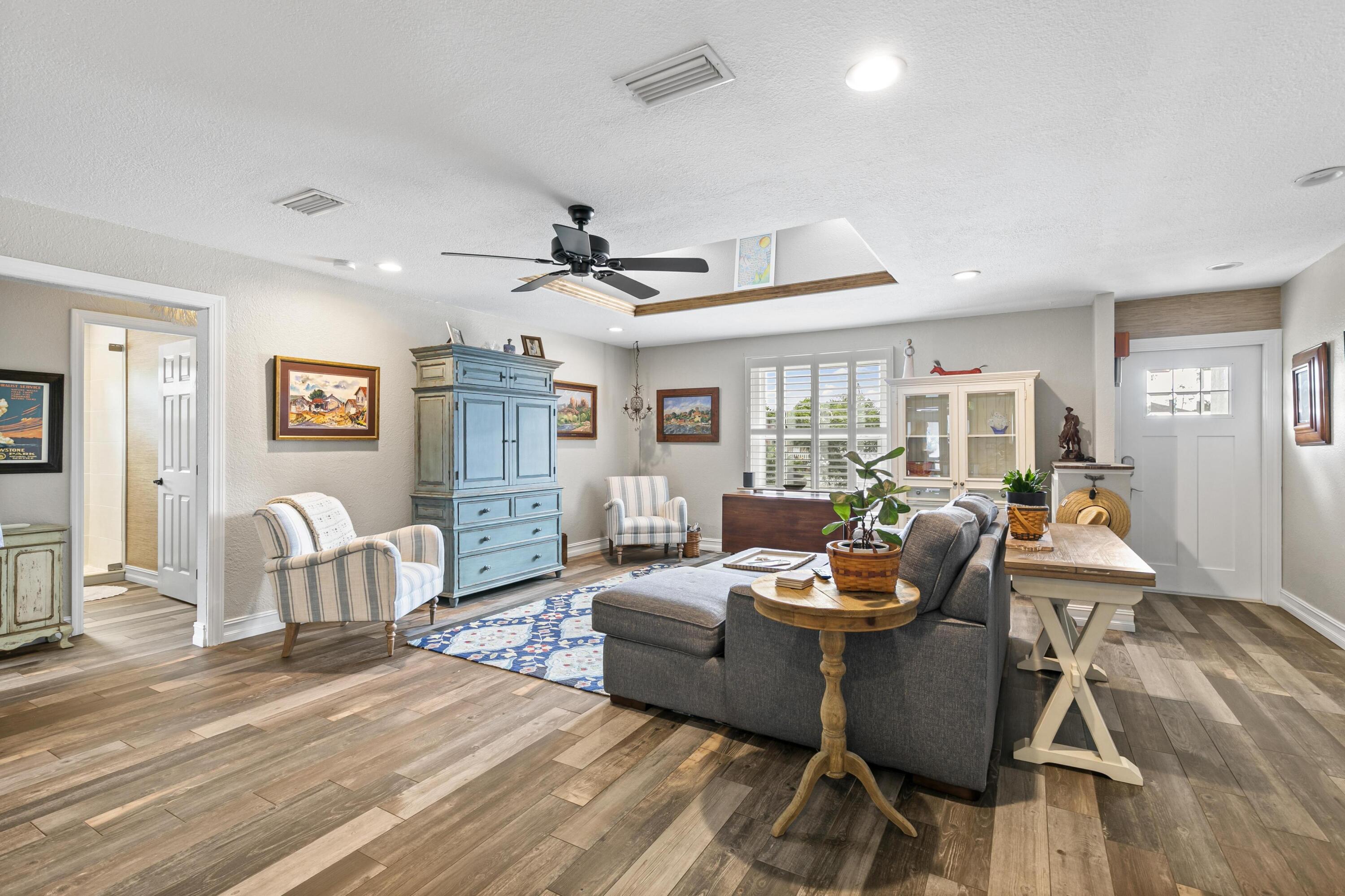 9025 Pomelo Road West Fort Myers, FL 33967 - Photo 2 of 27 a living room with furniture kitchen view and a wooden floor