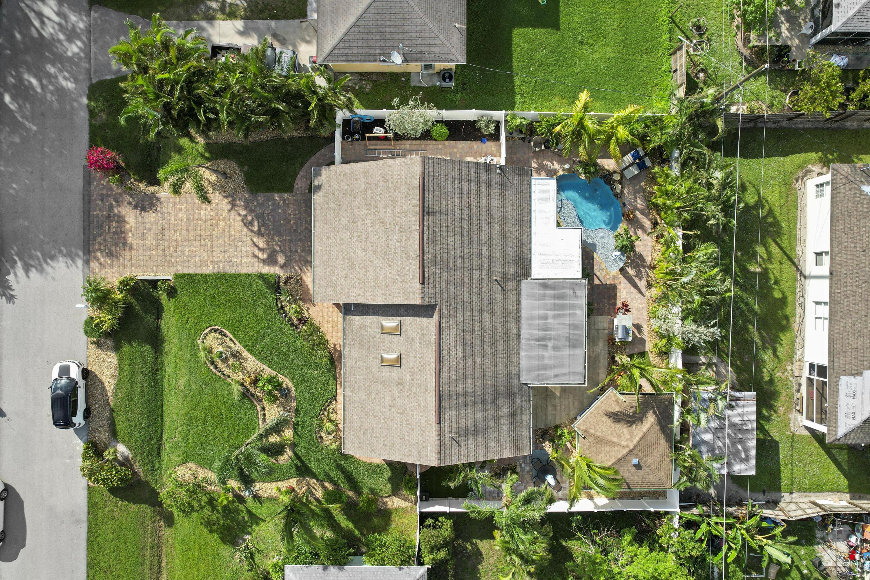 9025 Pomelo Road West Fort Myers, FL 33967 - Photo 25 of 27 an aerial view of a house with a garden and trees