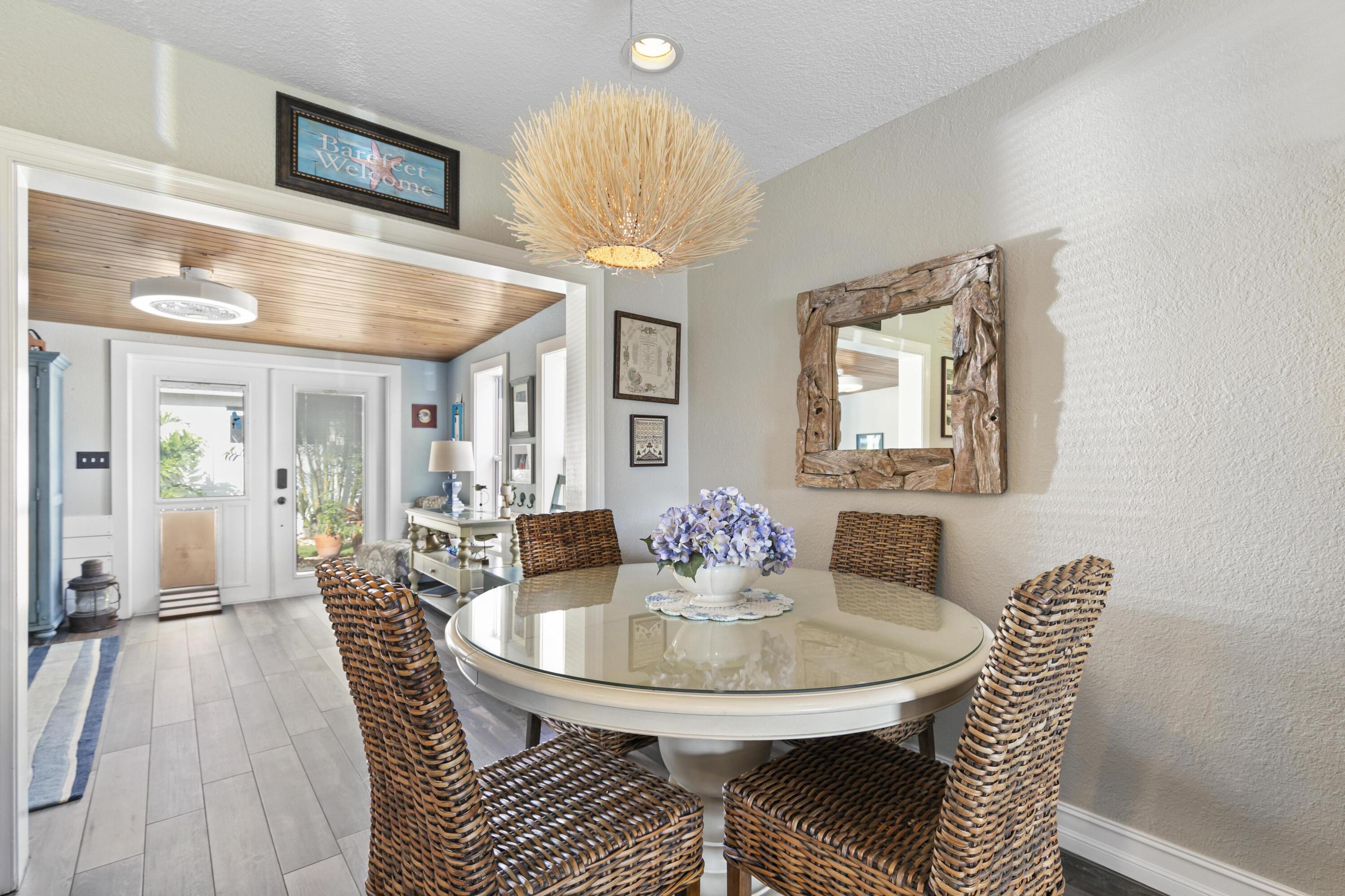 9025 Pomelo Road West Fort Myers, FL 33967 - Photo 7 of 27 a view of a dining room with furniture and wooden floor