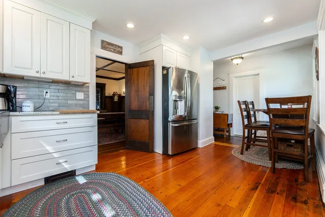 a kitchen with stainless steel appliances kitchen island granite countertop a refrigerator and microwave