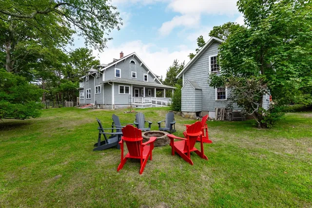 a backyard of a house with table and chairs