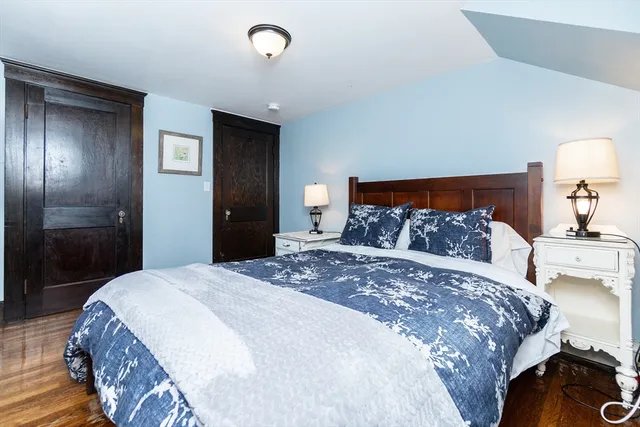 a bedroom with a bed and a lamp