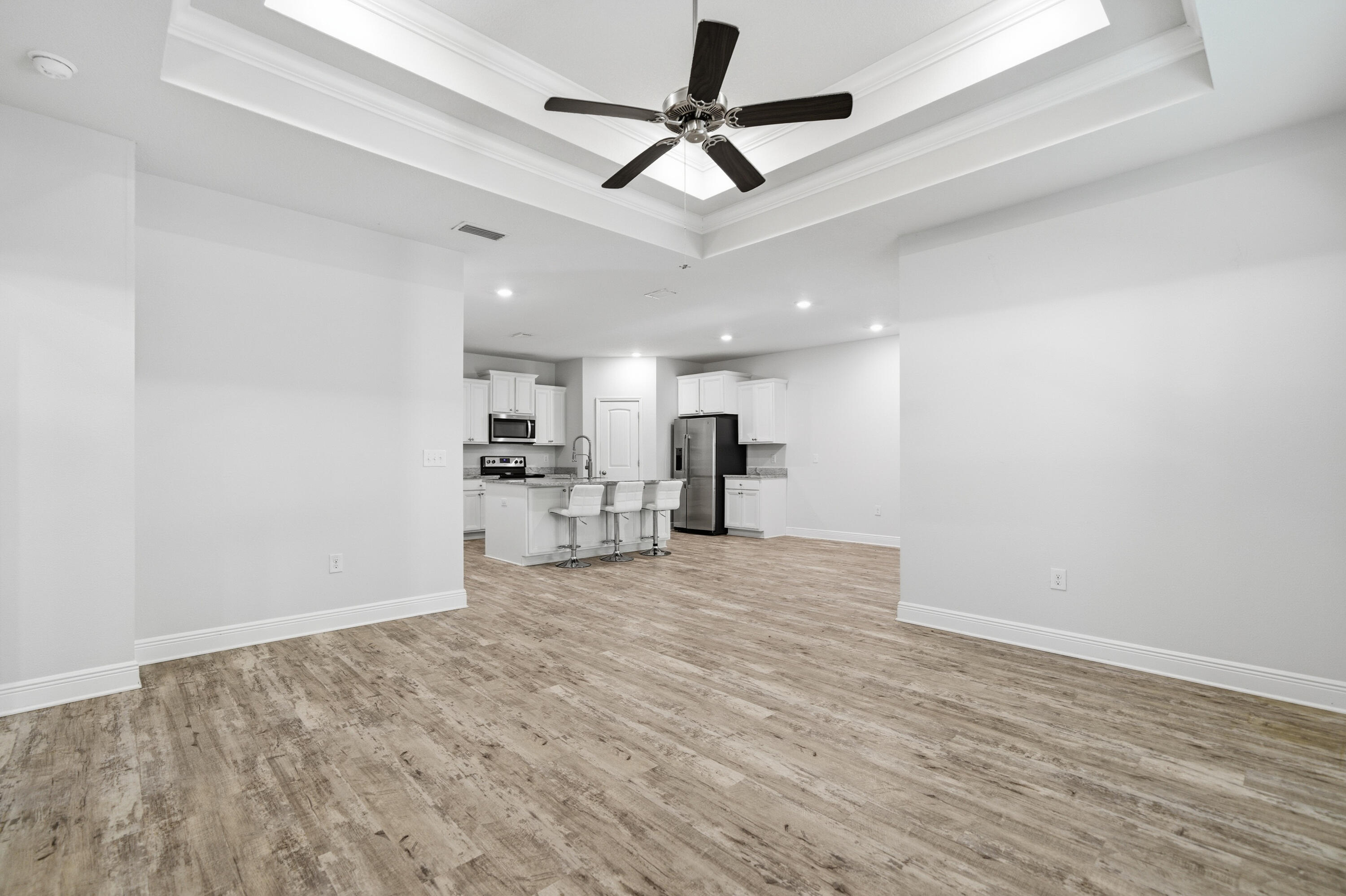 191 Southern Pnes Road Santa Rosa Beach, FL 32459 - Photo 16 of 46 a view of kitchen and empty room with wooden floor