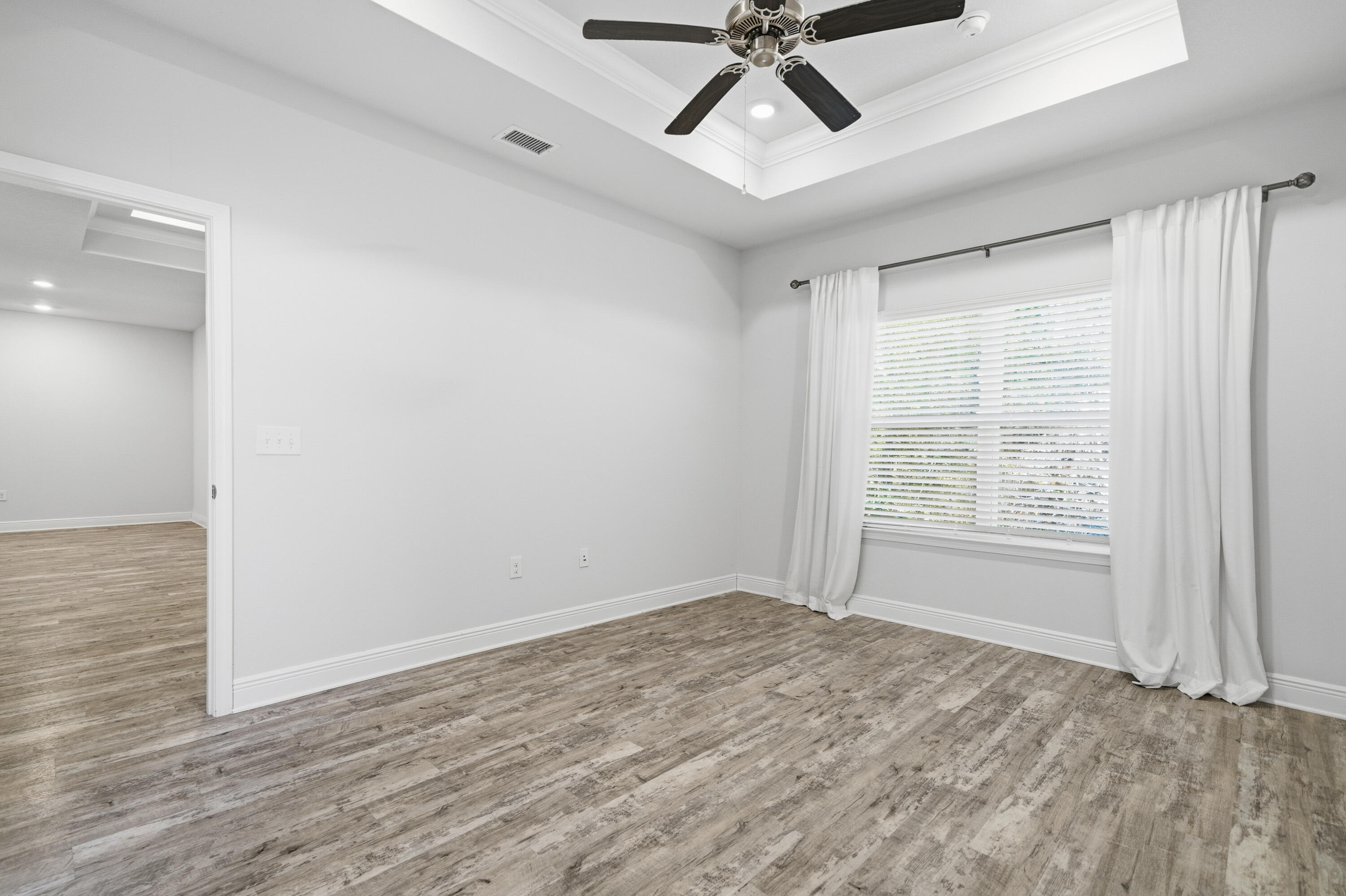 191 Southern Pnes Road Santa Rosa Beach, FL 32459 - Photo 20 of 46 a view of empty room with wooden floor and fan
