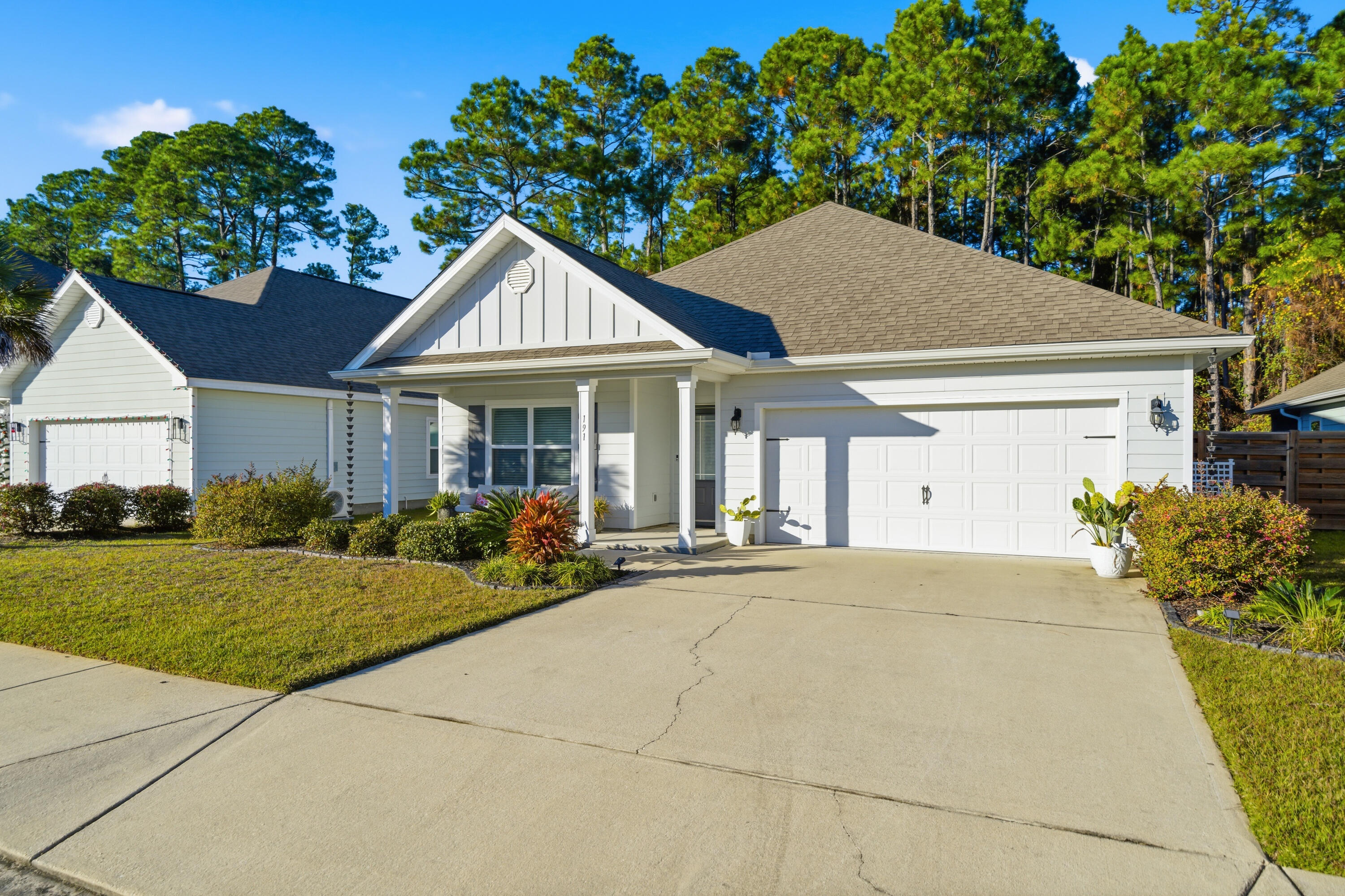 191 Southern Pnes Road Santa Rosa Beach, FL 32459 - Photo 2 of 46 a front view of a house with a yard and potted plants
