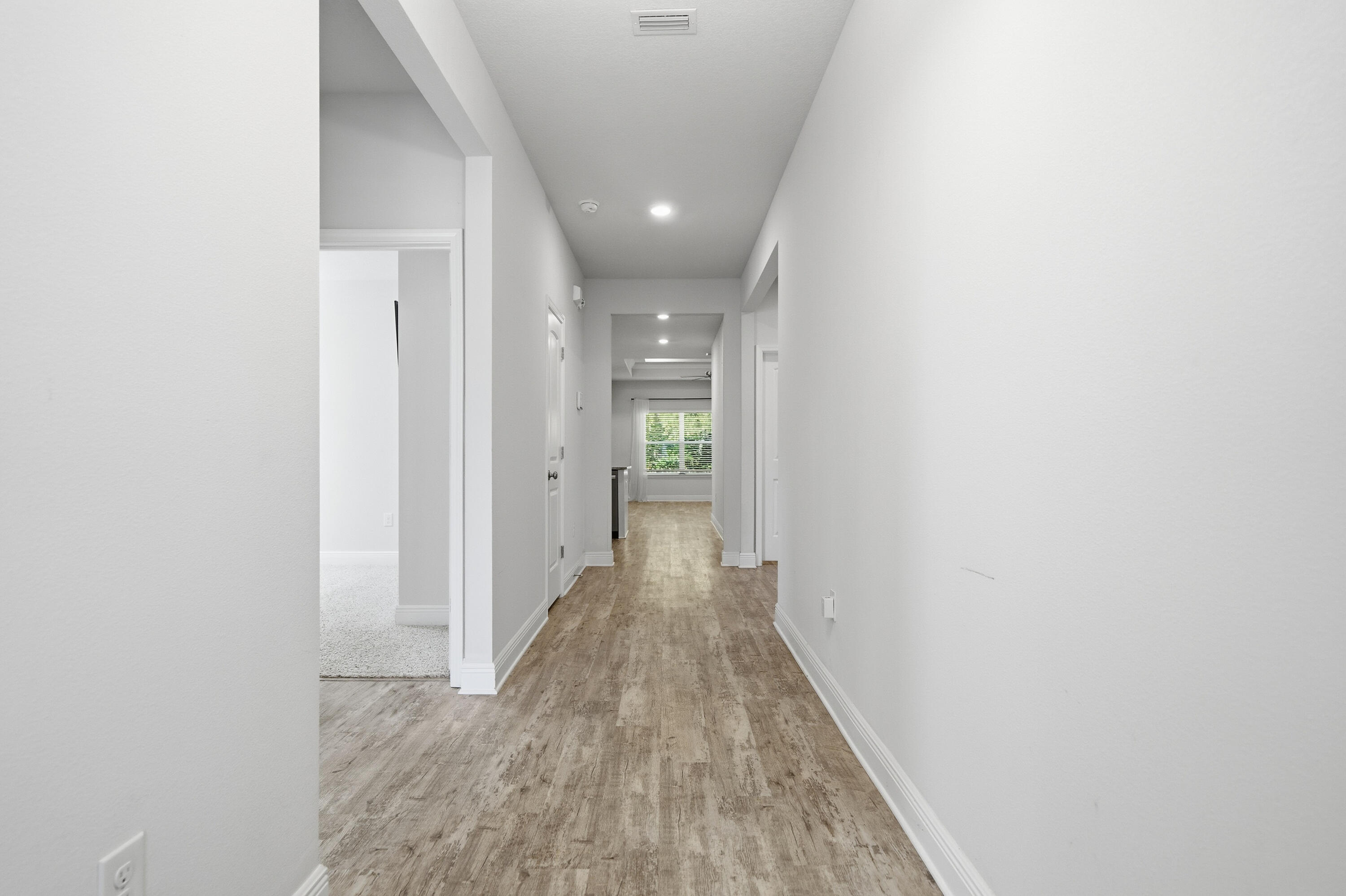 191 Southern Pnes Road Santa Rosa Beach, FL 32459 - Photo 29 of 46 a view of a hallway with wooden floor