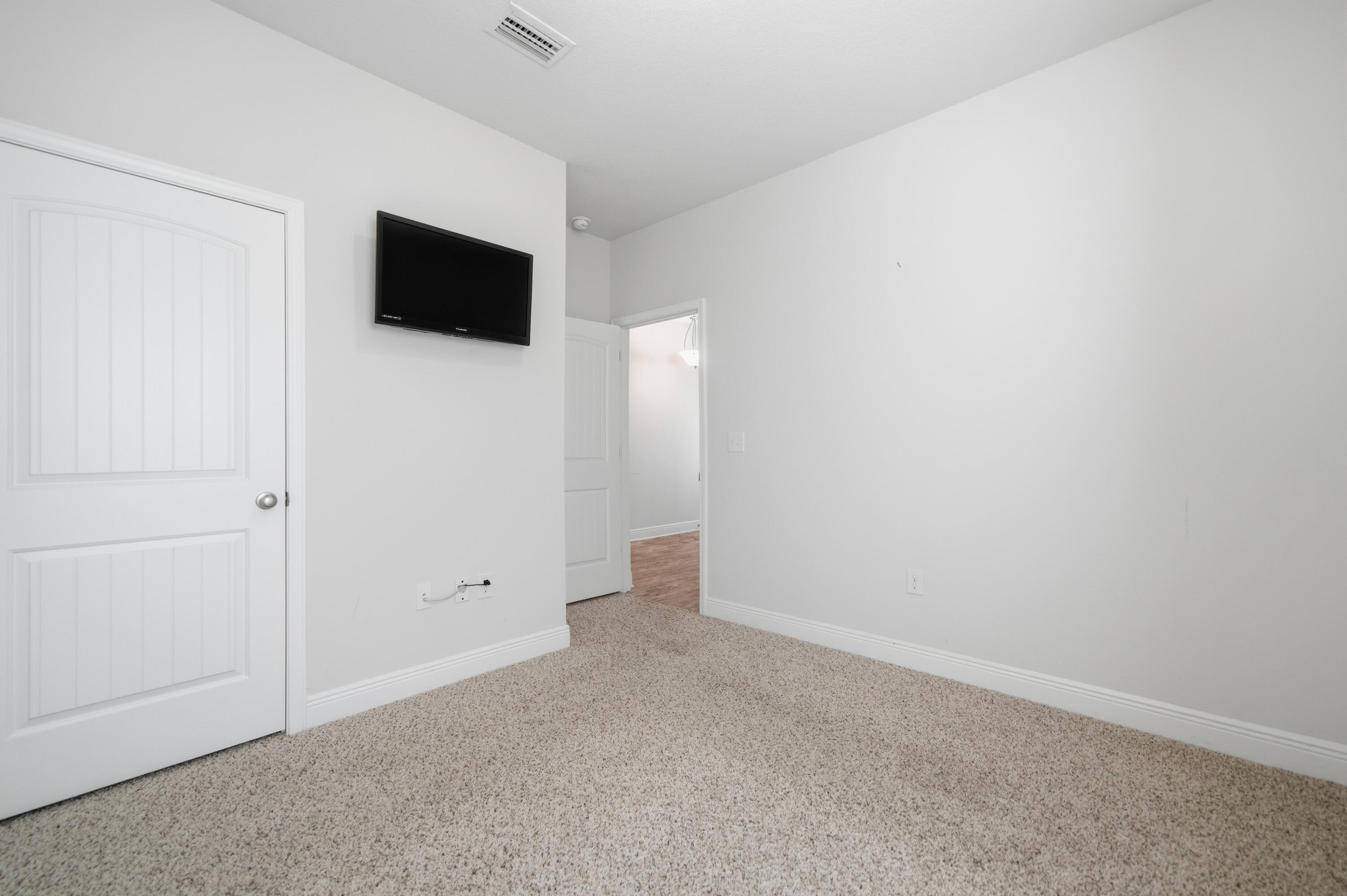 191 Southern Pnes Road Santa Rosa Beach, FL 32459 - Photo 39 of 46 a view of an empty room with tv and wooden floor