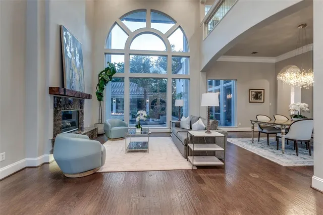 a living room with fireplace furniture and a wooden floor