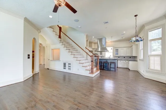 a view of an empty room and wooden floor in a room