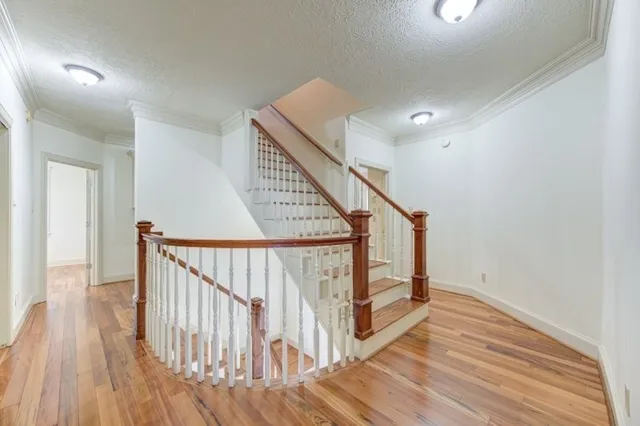 a view of a room with wooden floor and fan