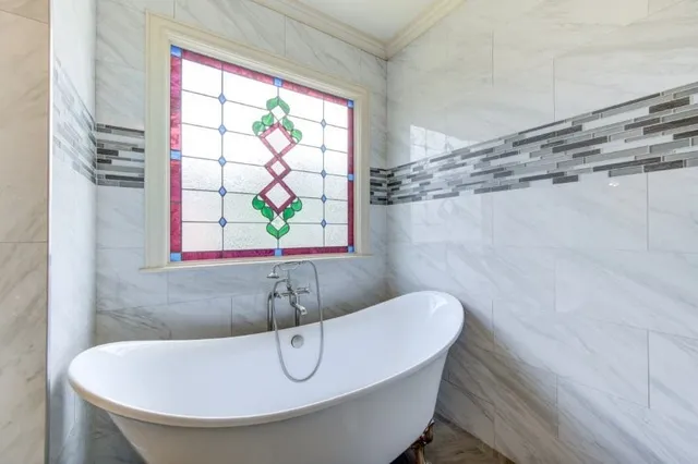 a bathroom with a bathtub and a shower