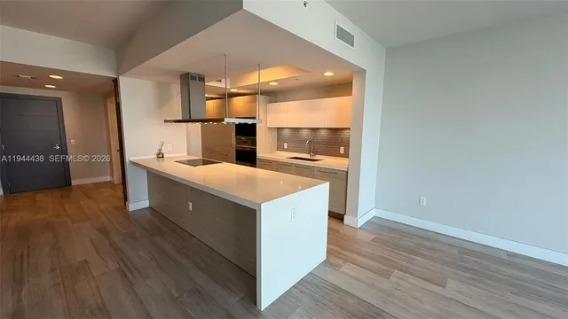 a kitchen with a sink and cabinets