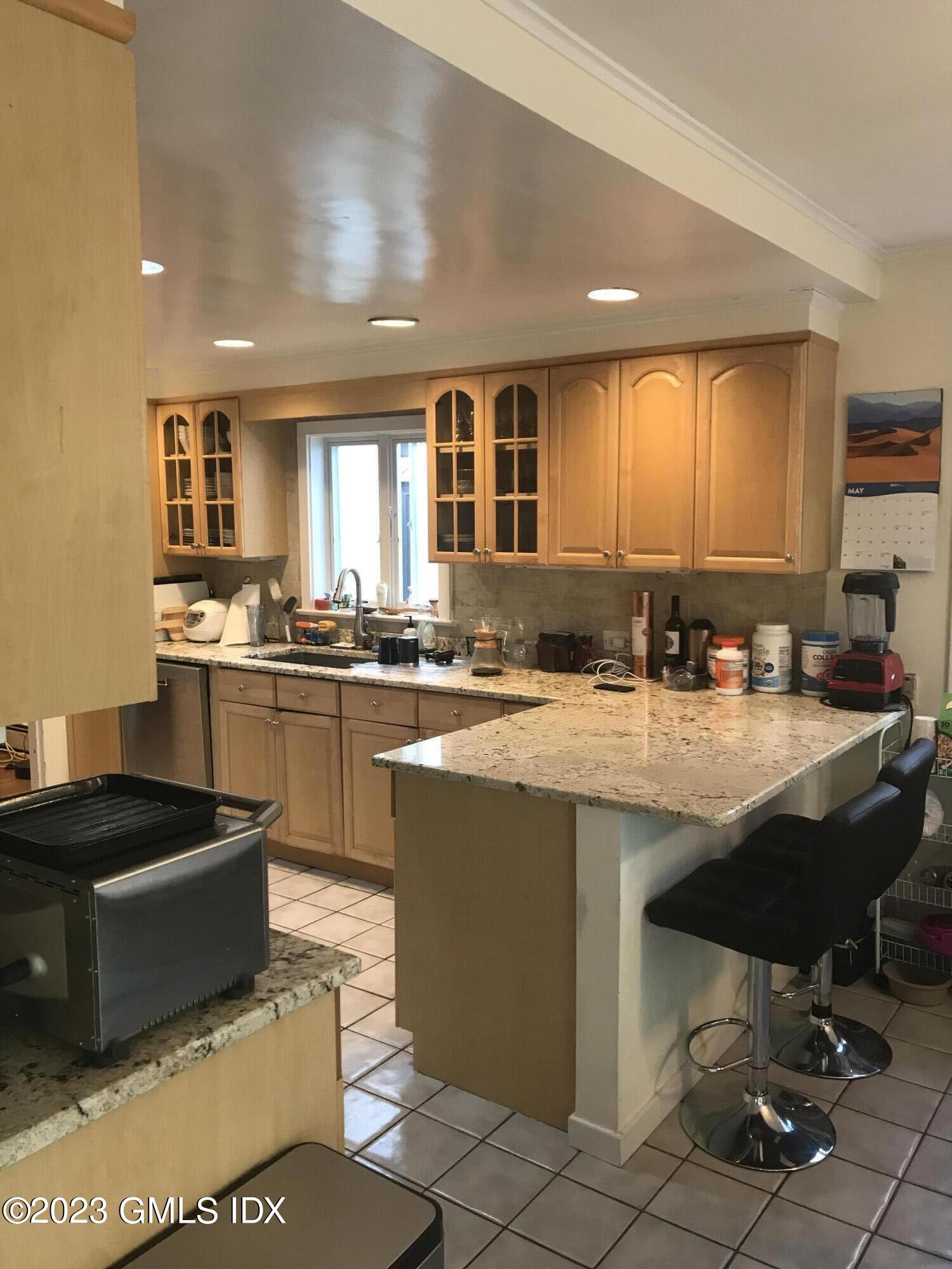 15 Ridge Road Cos Cob, CT 06807 - Photo 6 of 11 a kitchen with stainless steel appliances granite countertop a sink and a stove