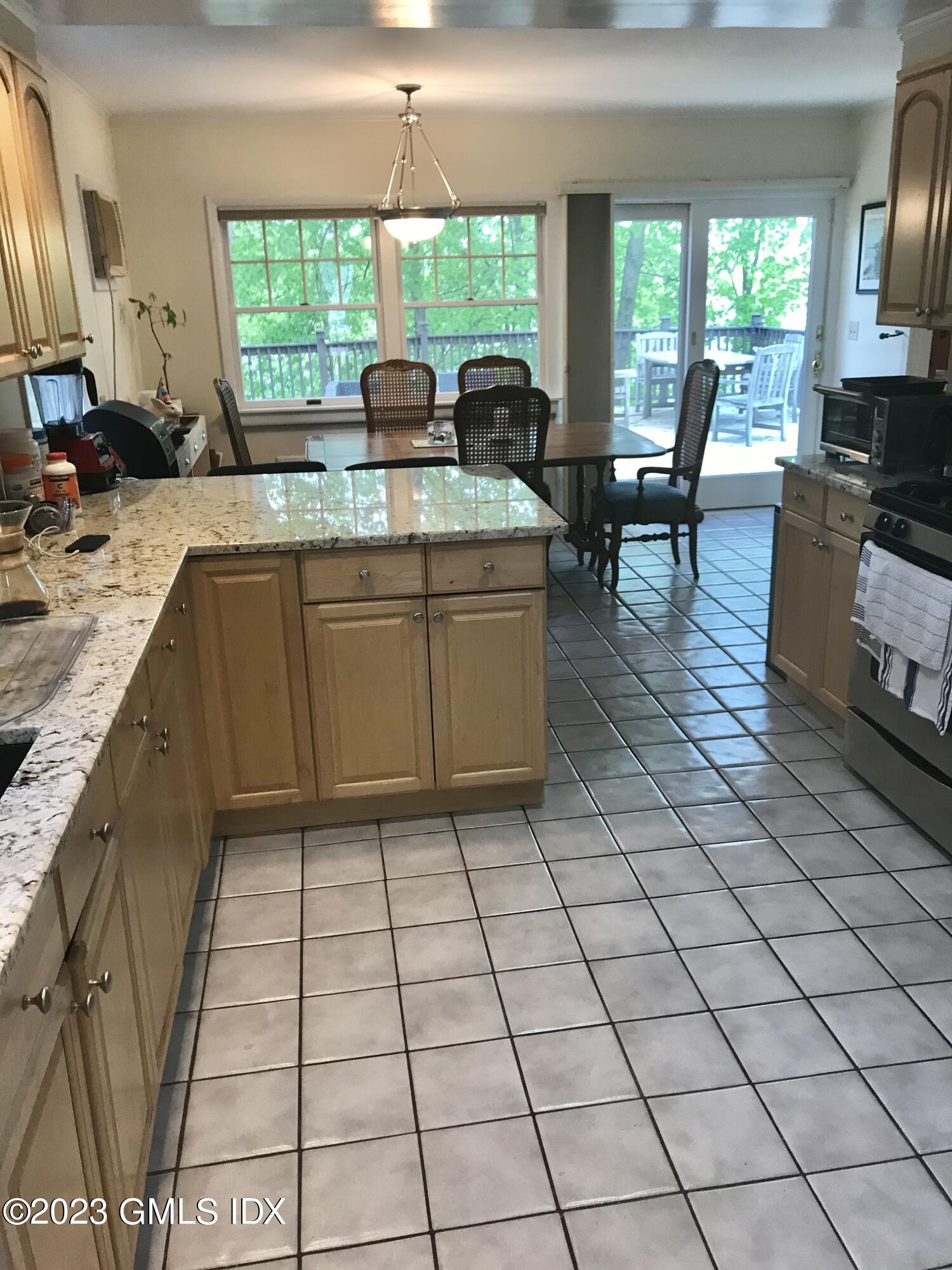 15 Ridge Road Cos Cob, CT 06807 - Photo 7 of 11 a kitchen with stainless steel appliances a stove a sink a counter top space and living room view
