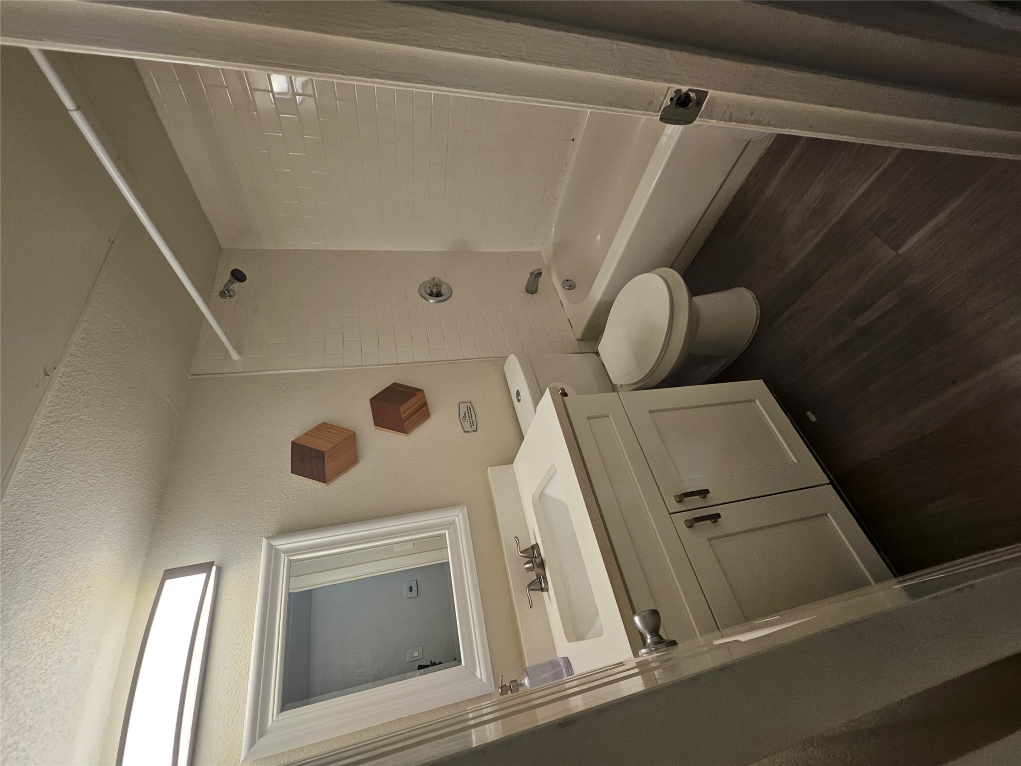 a bathroom with a toilet sink and shower