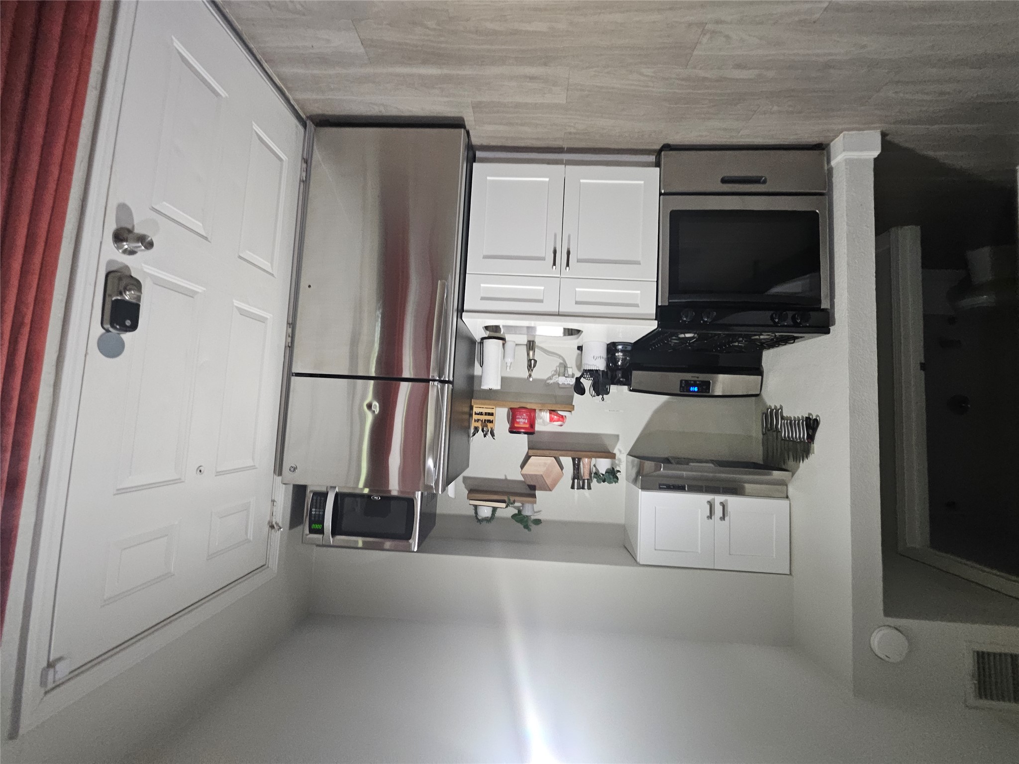 4501 Speedway, Unit 104 Austin, TX 78751 - Photo 6 of 7 a kitchen with a refrigerator stove and white cabinets