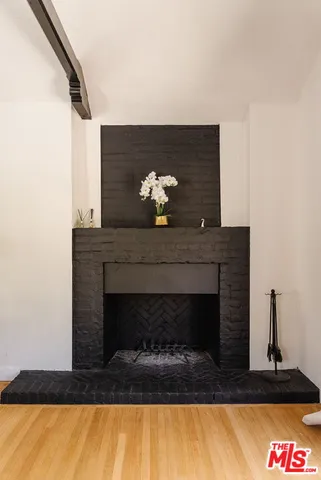 a living room with a fireplace and a potted plant