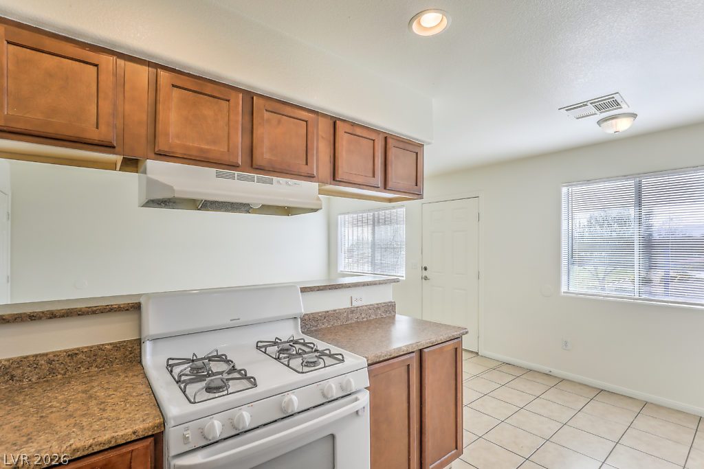 3127 North Walnut Road, Unit A Las Vegas, NV 89115 - Photo 6 of 12 A functional kitchen features generous cabinet storage, durable countertops, and convenient cooking appliances.