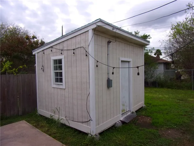 a view of a small house with backyard