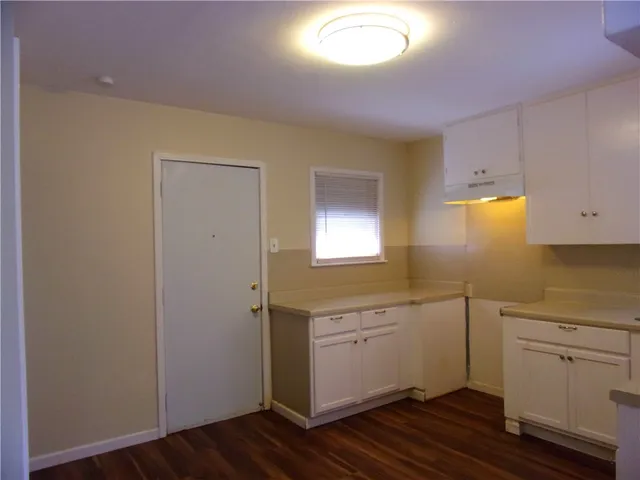 a view of a kitchen with wooden floor