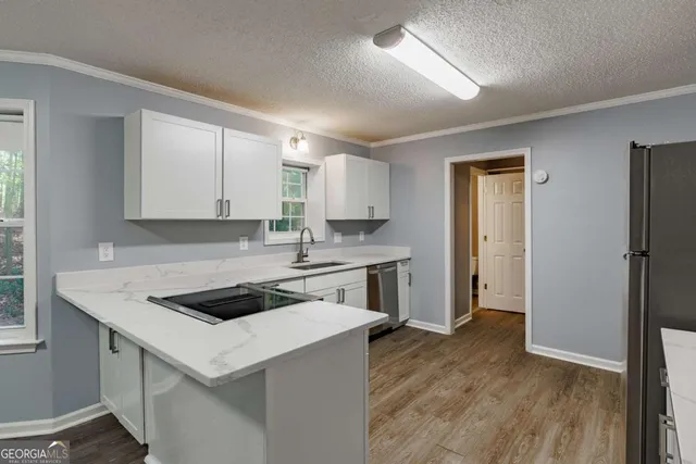 a kitchen that has a sink and a stove in it
