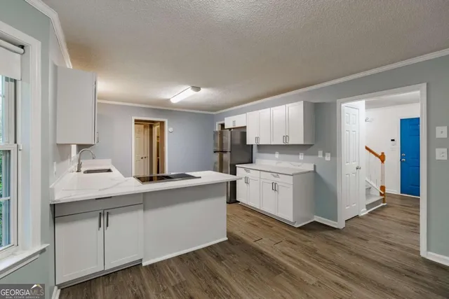 a kitchen with a sink stove and cabinets