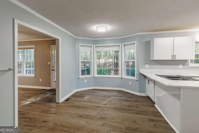 an empty room with wooden floor and a window