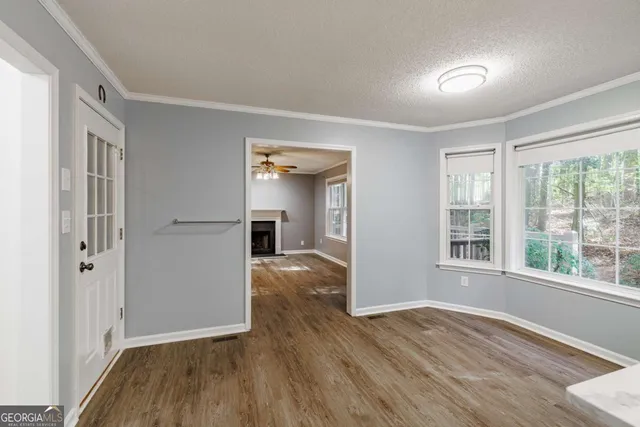 wooden floor in an empty room with a window